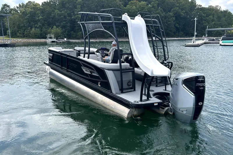 Slide: The Image of 2025 Godfrey AquaPatio 255 SDC Slide pontoon boat with slide on a lake. - 4