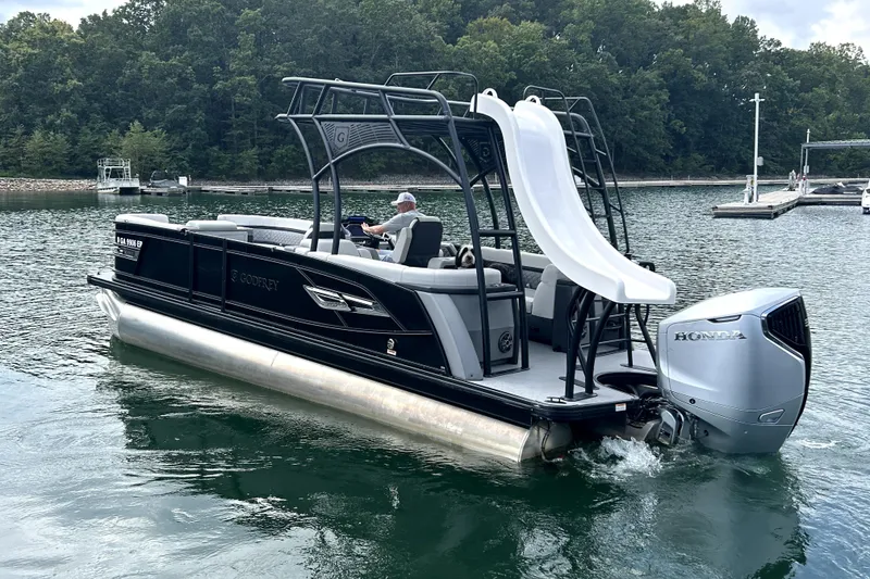 Slide: The Image of 2025 Godfrey AquaPatio 255 SDC Slide pontoon boat on a scenic lake. - 5