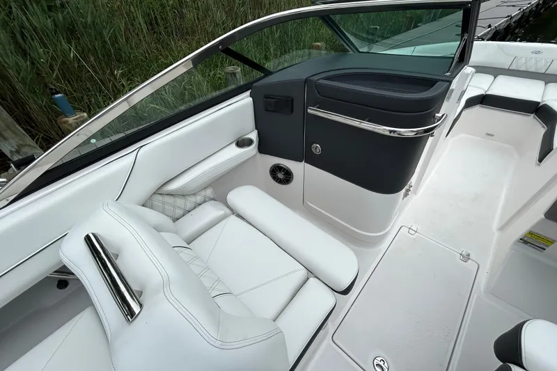Slide: The Image of 2022 Regal LX4 boat interior with white seating and sleek design. - 13