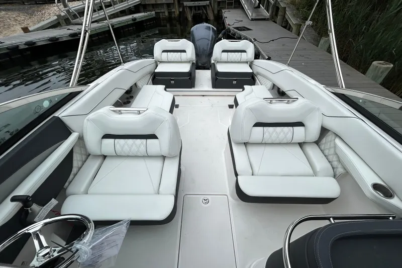 Slide: The Image of 2022 Regal LX4 boat interior with luxurious white seating and sleek design. - 16