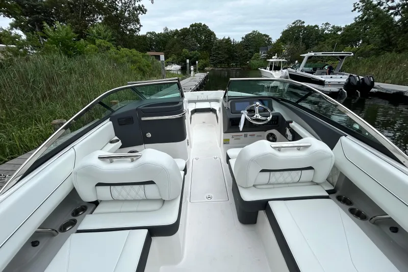 Slide: The Image of 2022 Regal LX4 boat interior with white seating and sleek dashboard design. - 6
