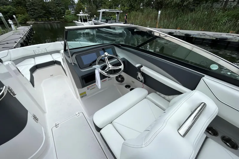 Slide: The Image of 2022 Regal LX4 boat interior with sleek white seating and modern dashboard. - 7