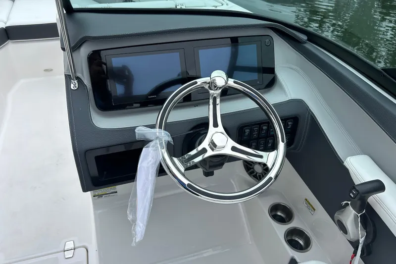 Slide: The Image of 2022 Regal LX4 boat dashboard with dual screens and steering wheel. - 8