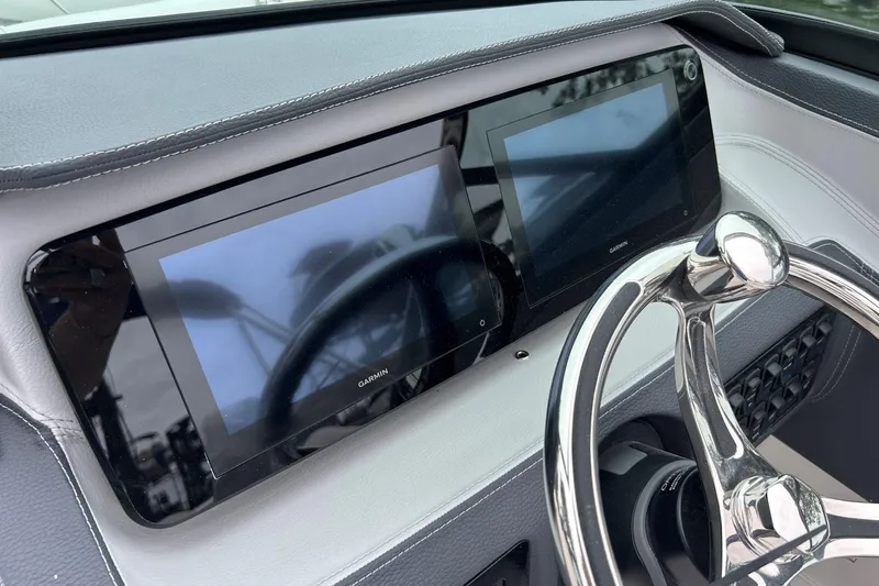 Slide: The Image of 2022 Regal LX4 dashboard with dual Garmin displays and sleek steering wheel. - 9