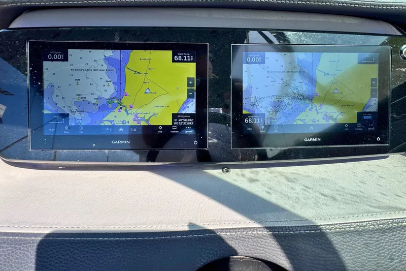 Slide: The Image of Dashboard of 2023 Regal LX4 with dual Garmin navigation screens displaying nautical maps. - 12