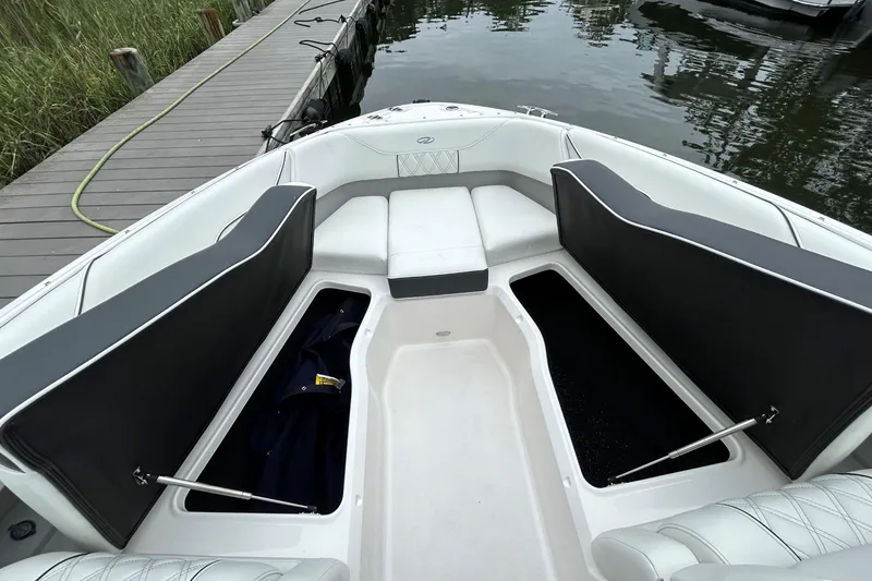 Slide: The Image of 2022 Regal LX4 boat interior with open storage compartments at dockside. - 17