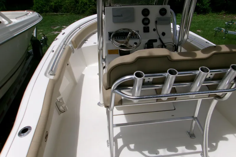Slide: The Image of 2020 Key West 219 FS boat interior with steering console and rod holders. - 13