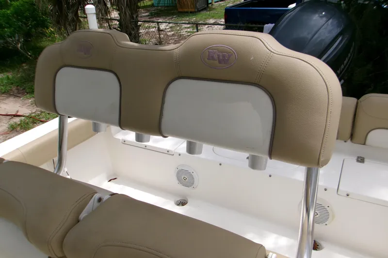 Slide: The Image of 2020 Key West 219 FS boat seating with beige upholstery and rod holders. - 14