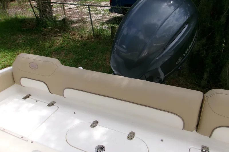 Slide: The Image of 2020 Key West 219 FS boat with Yamaha outboard motor, beige seating, and storage compartments. - 15