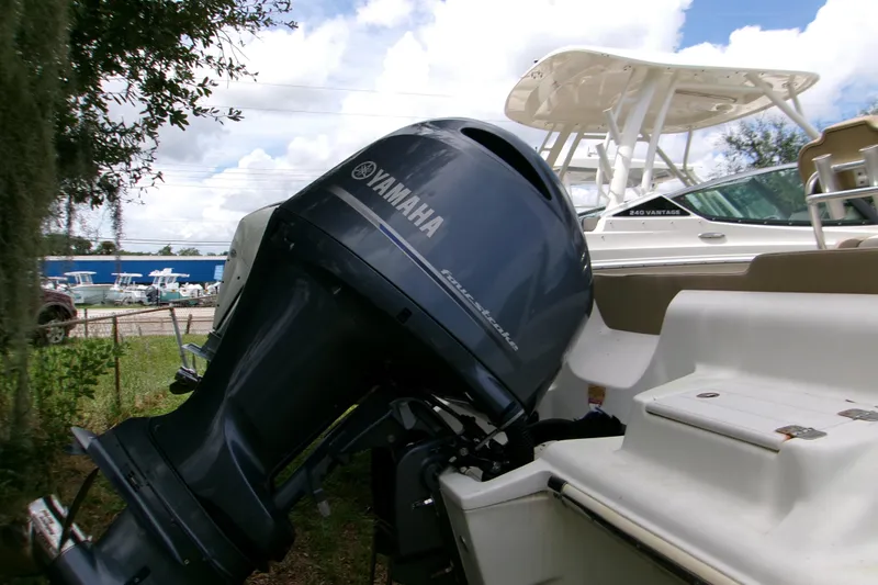 Slide: The Image of 2020 Key West 219 FS boat with Yamaha outboard motor, parked outdoors. - 7