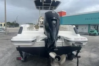 Slide: The Image of 2023 Bayliner Trophy T22CC boat with outboard motor, parked outdoors. - 4
