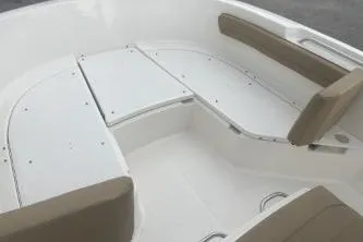 Slide: The Image of 2023 Bayliner Trophy T22CC boat interior with cushioned seating and storage compartments. - 9