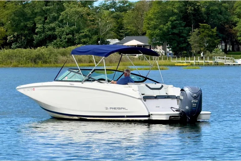 The Image of 2022 Regal 23 OBX boat with canopy on a serene lake. - 0