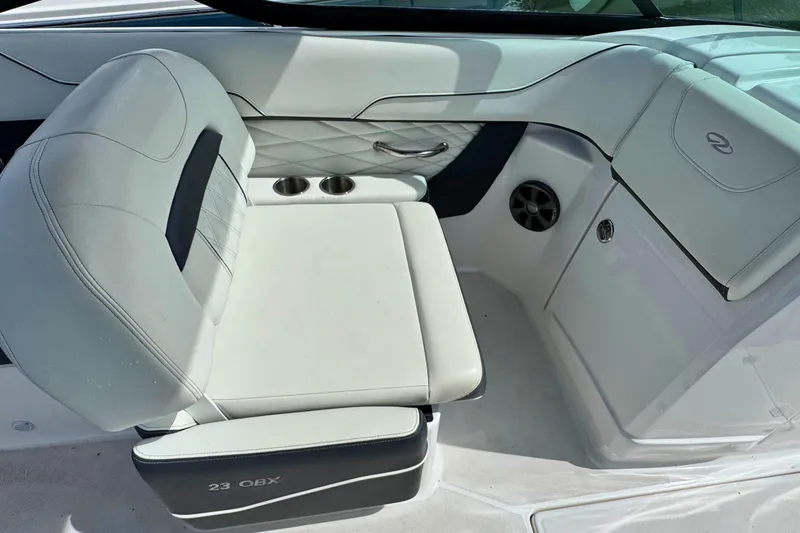 Slide: The Image of 2022 Regal 23 OBX boat interior with white seating and cup holders. - 11