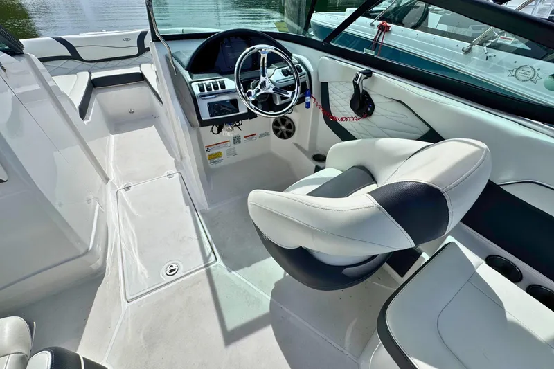 Slide: The Image of Interior of a 2022 Regal 23 OBX boat with modern steering and seating. - 12