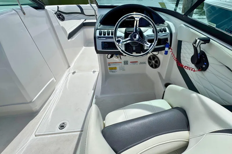 Slide: The Image of Interior view of 2022 Regal 23 OBX boat, featuring steering wheel and seating. - 13