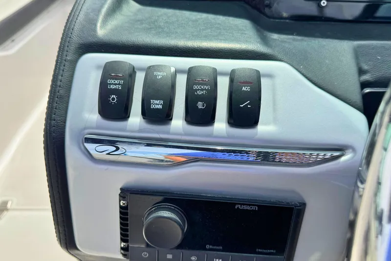 Slide: The Image of Control panel of 2022 Regal 23 OBX boat with switches and audio system. - 16