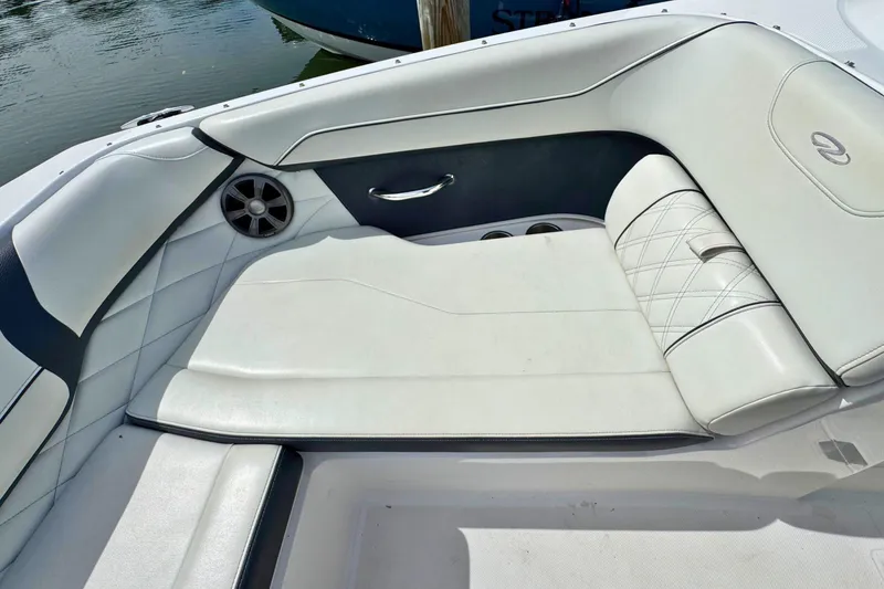 Slide: The Image of Luxurious seating on 2022 Regal 23 OBX boat, featuring white upholstery and speaker system. - 19