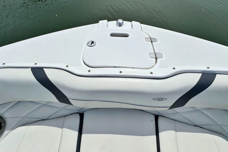 Slide: The Image of 2022 Regal 23 OBX boat interior with white seating and storage compartment. - 20