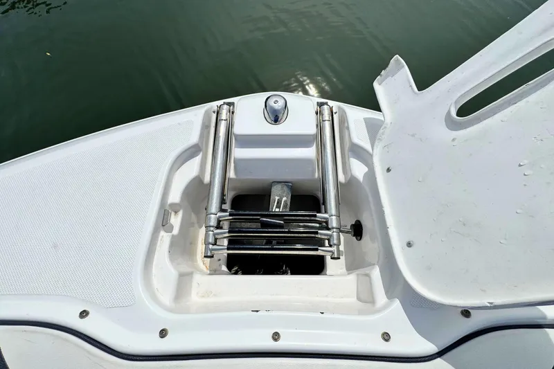 Slide: The Image of 2022 Regal 23 OBX boat ladder compartment, open on calm water. - 21