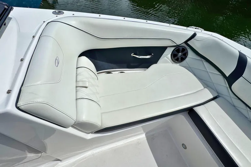 Slide: The Image of 2022 Regal 23 OBX boat interior with white cushioned seating and speaker detail. - 22