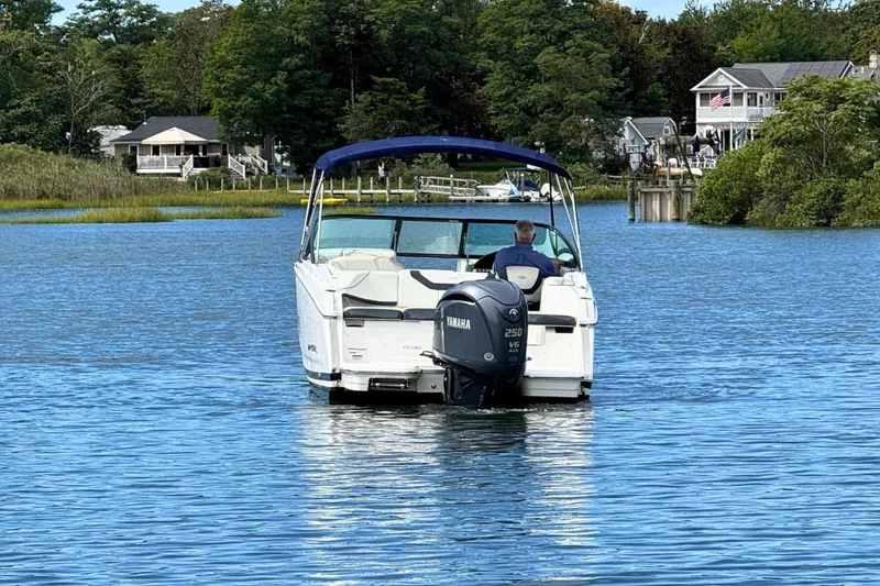 Slide: The Image of 2022 Regal 23 OBX boat with Yamaha engine on a serene lake. - 7