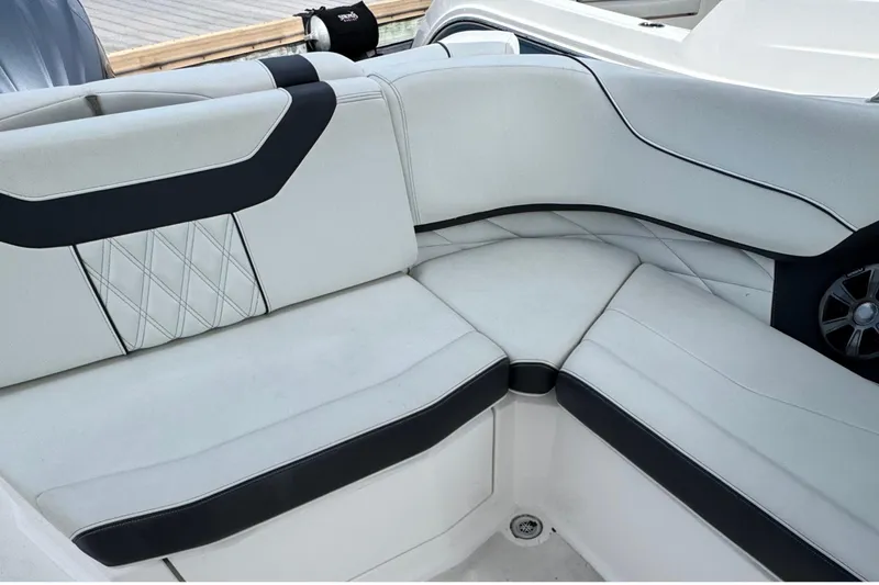 Slide: The Image of Luxurious seating on 2022 Regal 23 OBX boat, featuring elegant white and black upholstery. - 9
