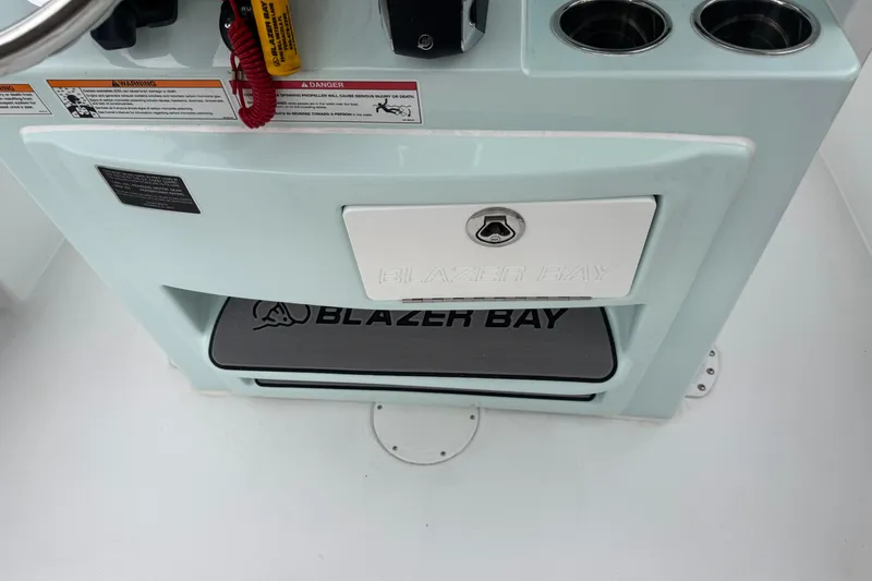 Slide: The Image of 2026 Blazer Bay 2440 boat console with storage compartment and cup holders. - 13