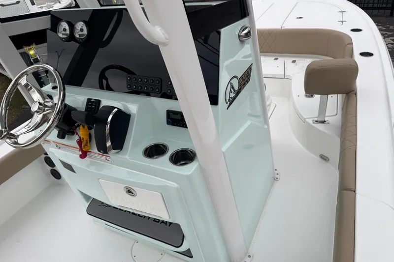 Slide: The Image of 2026 Blazer Bay 2440 boat interior with steering console and seating area. - 14