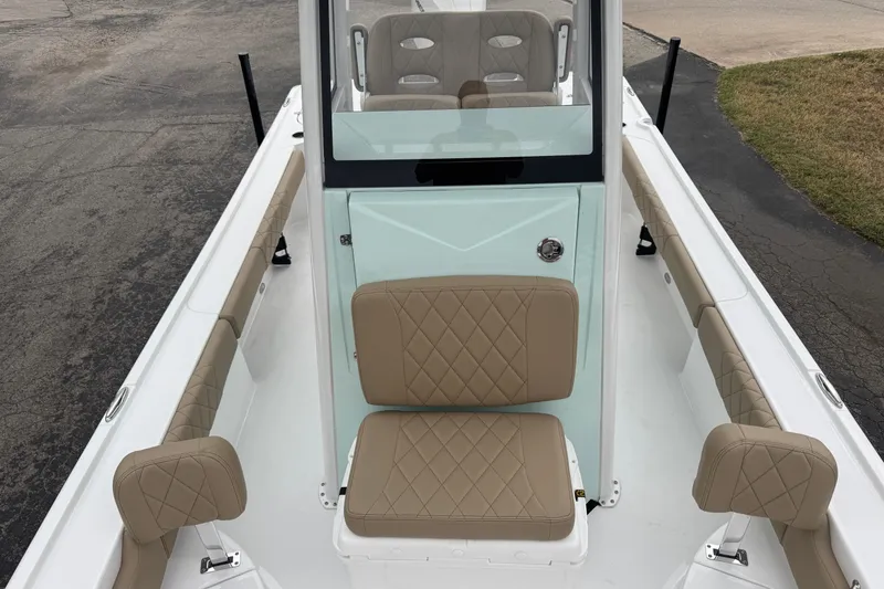Slide: The Image of 2026 Blazer Bay 2440 boat interior with tan quilted seats and sleek design. - 15