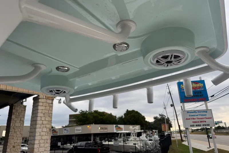Slide: The Image of 2026 Blazer Bay 2440 boat speakers and rod holders, dealership in background. - 16