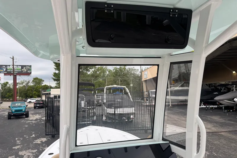Slide: The Image of 2026 Blazer Bay 2440 boat interior view at dealership, showcasing windshield and console. - 17