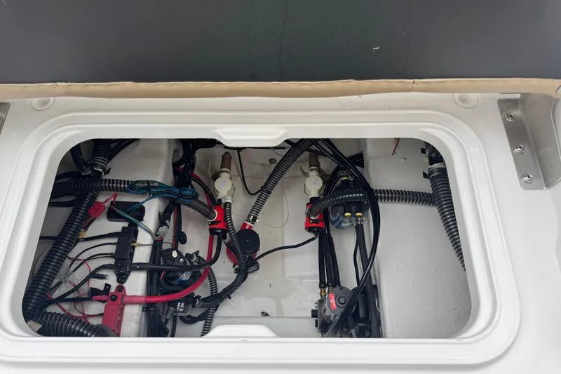 Slide: The Image of 2026 Blazer Bay 2440 boat wiring and components inside a compartment. - 25