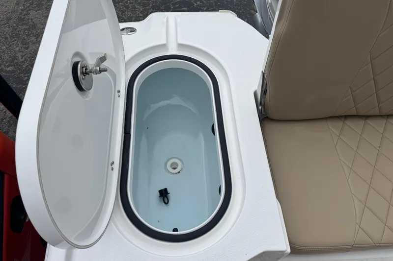 Slide: The Image of Open storage compartment on 2026 Blazer Bay 2440 boat with beige seating. - 27