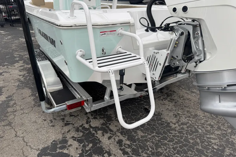 Slide: The Image of 2026 Blazer Bay 2440 boat rear view with motor and boarding ladder. - 3