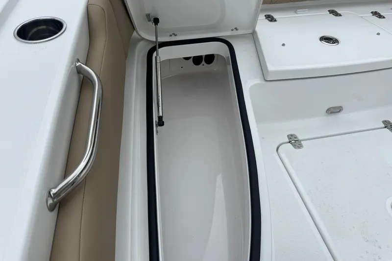 Slide: The Image of 2026 Blazer Bay 2440 boat storage compartment with stainless steel handle and cushioned seating. - 33