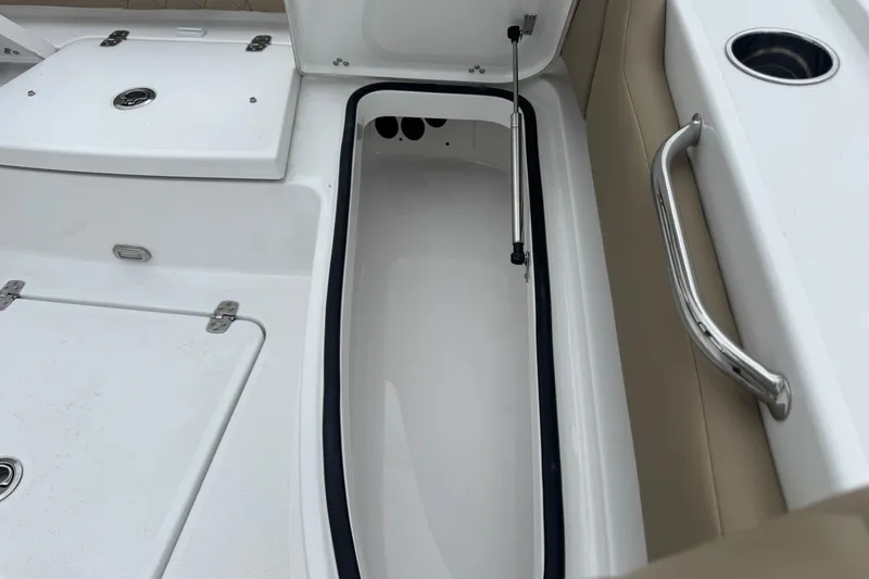Slide: The Image of Open storage compartment on 2026 Blazer Bay 2440 boat, featuring sleek design and stainless steel handle. - 34
