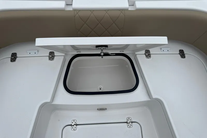 Slide: The Image of 2026 Blazer Bay 2440 boat storage compartment with open lid and secure hinges. - 35