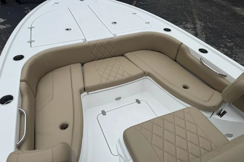 Slide: The Image of 2026 Blazer Bay 2440 boat interior with beige cushioned seating and white deck. - 36