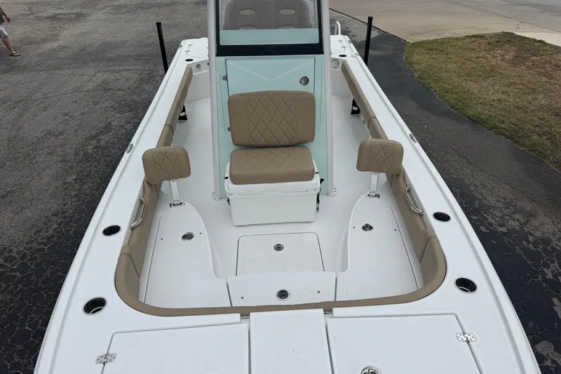 Slide: The Image of 2026 Blazer Bay 2440 boat interior with beige seating and white deck. - 42
