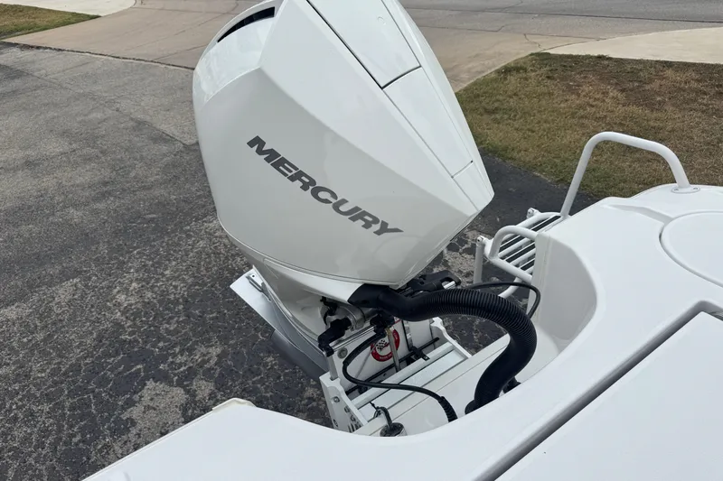 Slide: The Image of White Mercury outboard motor on 2026 Blazer Bay 2440 boat, parked on pavement. - 43