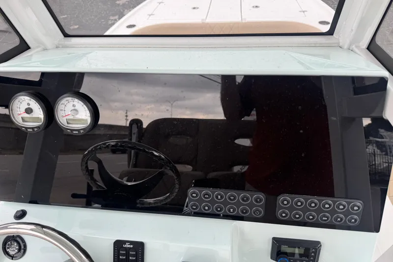 Slide: The Image of 2026 Blazer Bay 2440 boat dashboard with gauges and controls. - 9