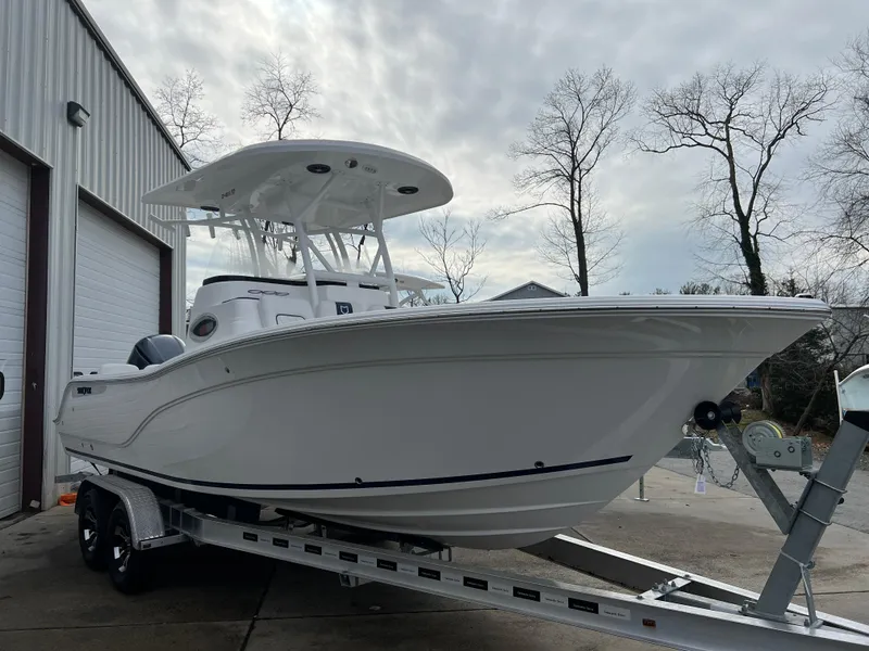 Slide: The Image of 2024 Sea Fox 248 Side Console boat on trailer near garage. - 1