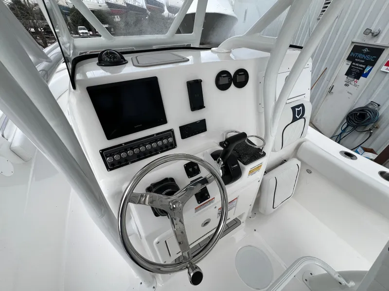 Slide: The Image of 2024 Sea Fox 248 Side Console boat dashboard with steering wheel and controls. - 10