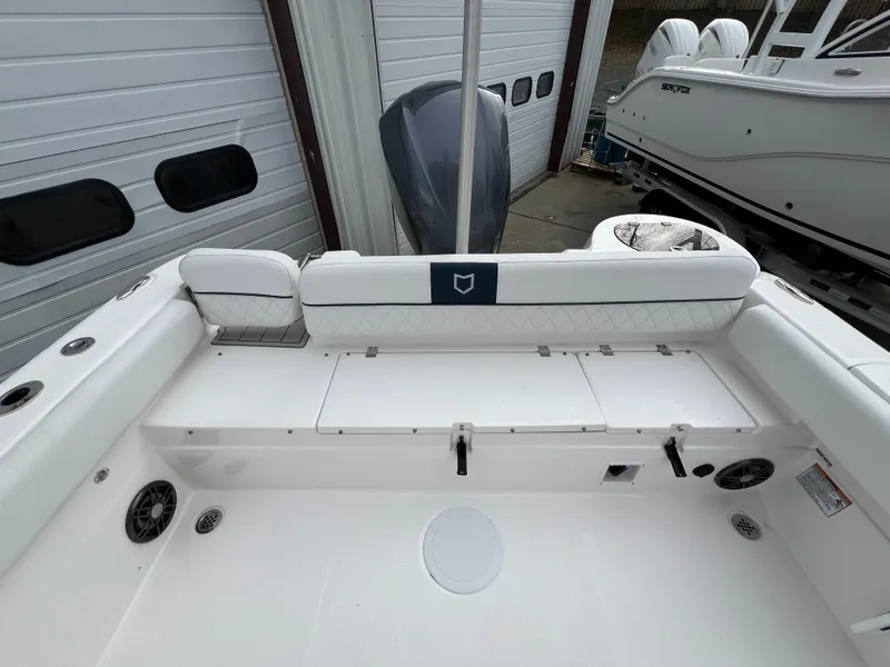 Slide: The Image of 2024 Sea Fox 248 Side Console boat interior with white seating and storage compartments. - 15