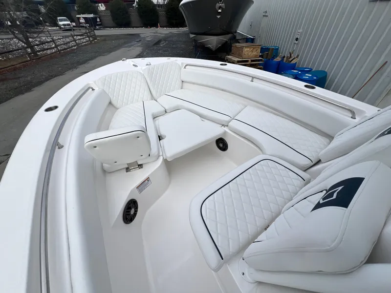 Slide: The Image of 2024 Sea Fox 248 Side Console boat with white cushioned seating and sleek design. - 6