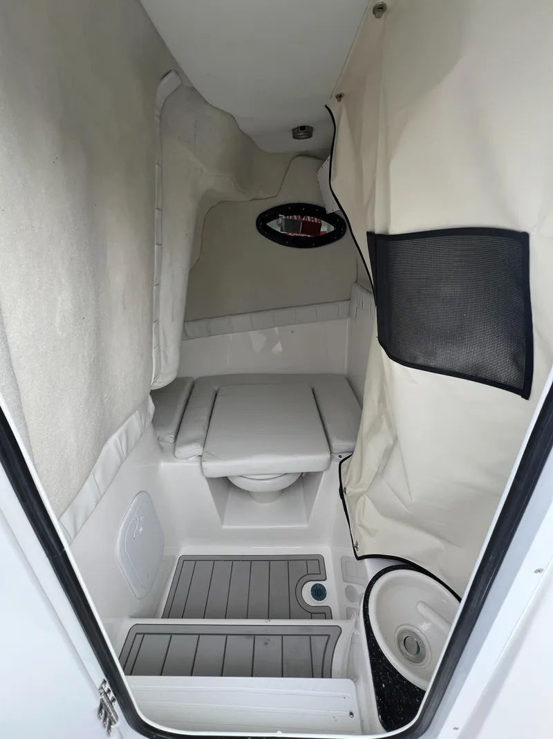 Slide: The Image of 2024 Sea Fox 248 Side Console interior cabin with seating and storage. - 7