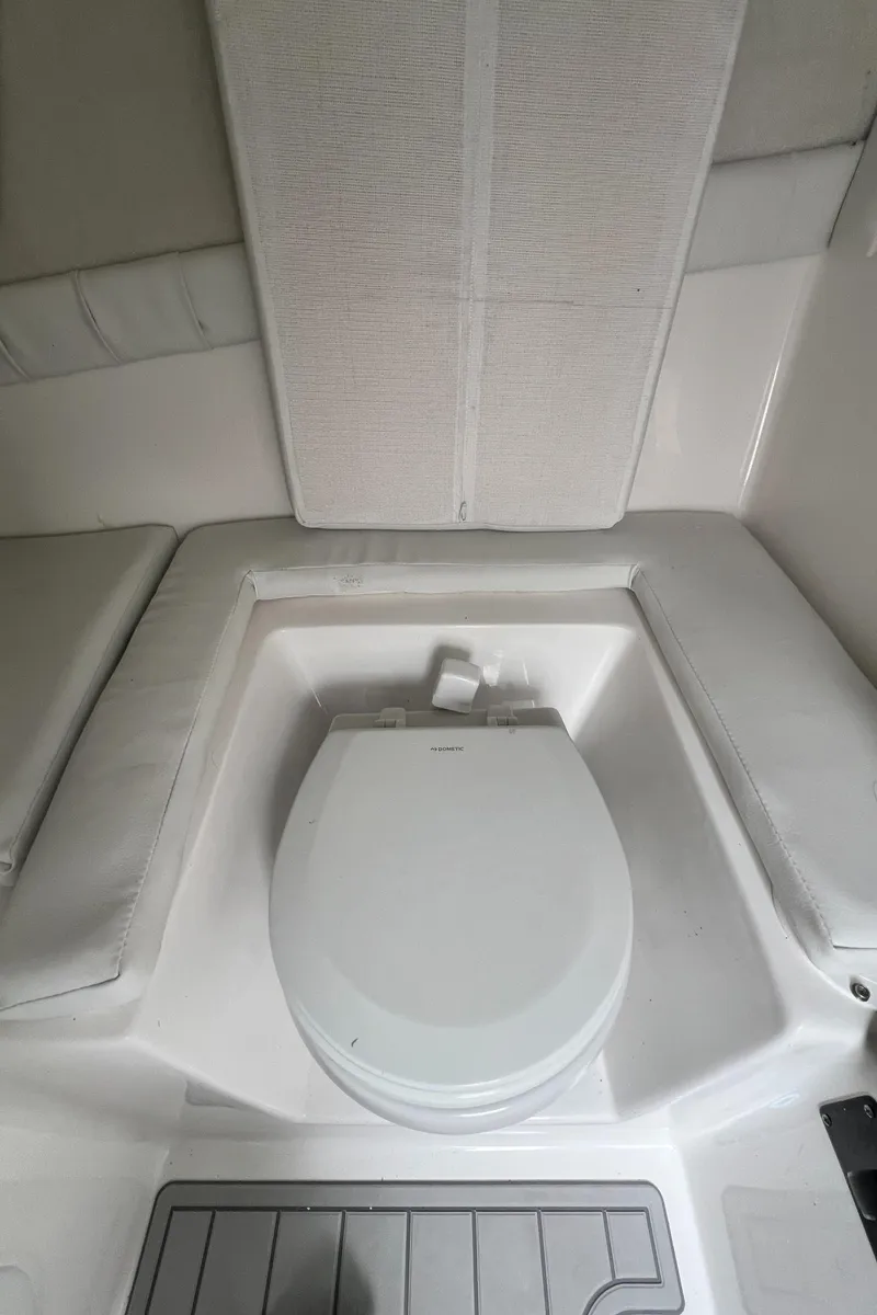 Slide: The Image of 2024 Sea Fox 248 Side Console boat interior with built-in toilet. - 8