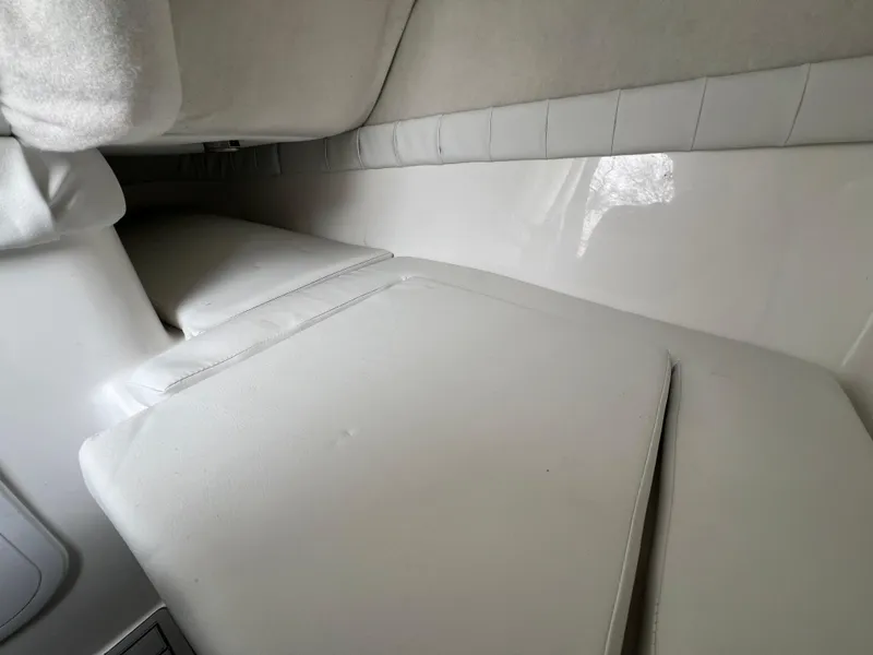 Slide: The Image of 2024 Sea Fox 248 Side Console interior cabin with white cushioned seating. - 9