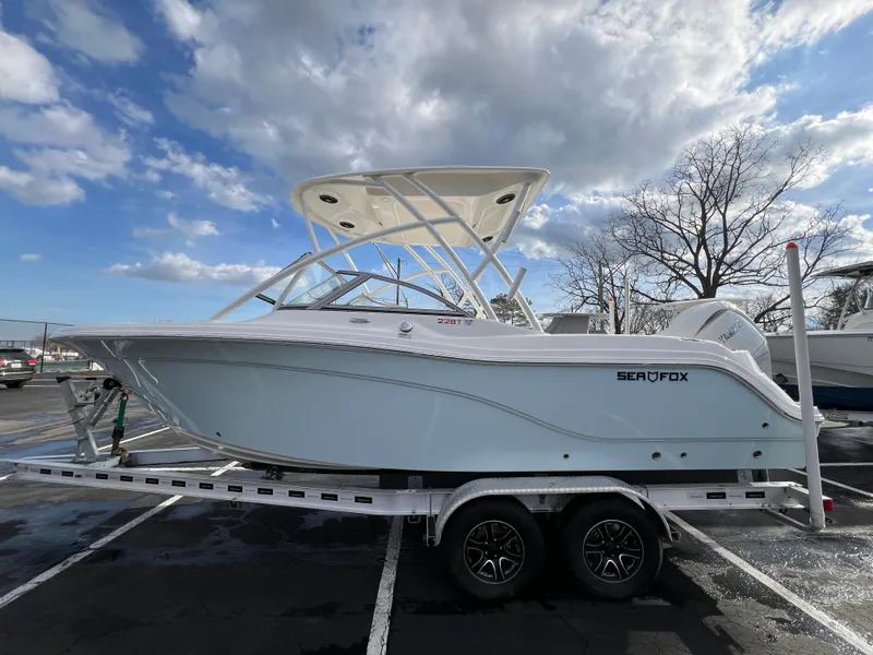 Slide: The Image of 2024 Sea Fox 228 Traveler boat on trailer under cloudy sky. - 14